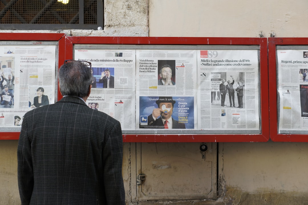 man-reading-newspaper-in-bulletin-board-c5qdmcuflgy